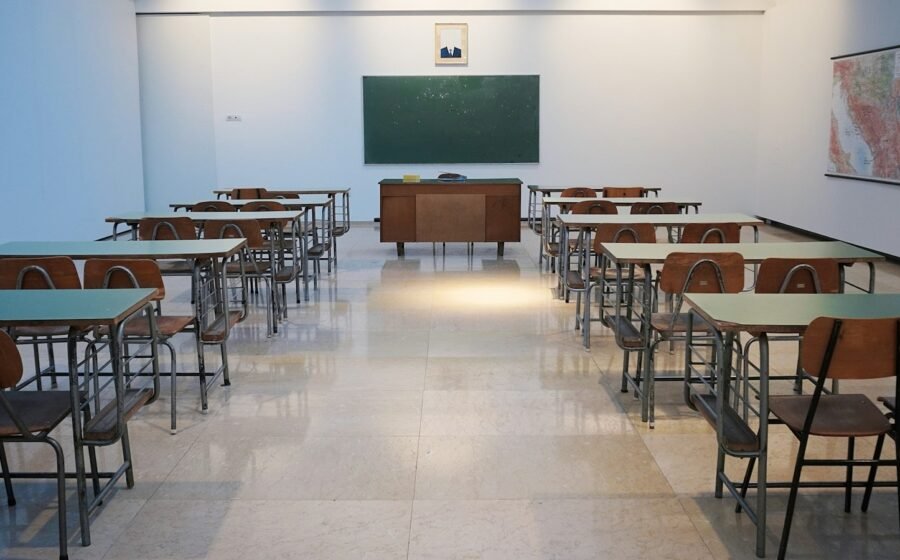 Empty classroom with rows of desks; illustrative stock photograph, not an SFUSD campus.