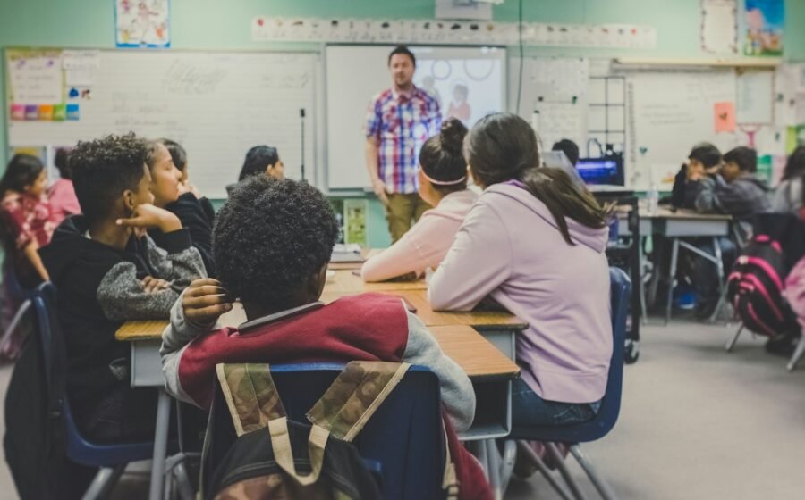 Teacher leading a class of students in a classroom