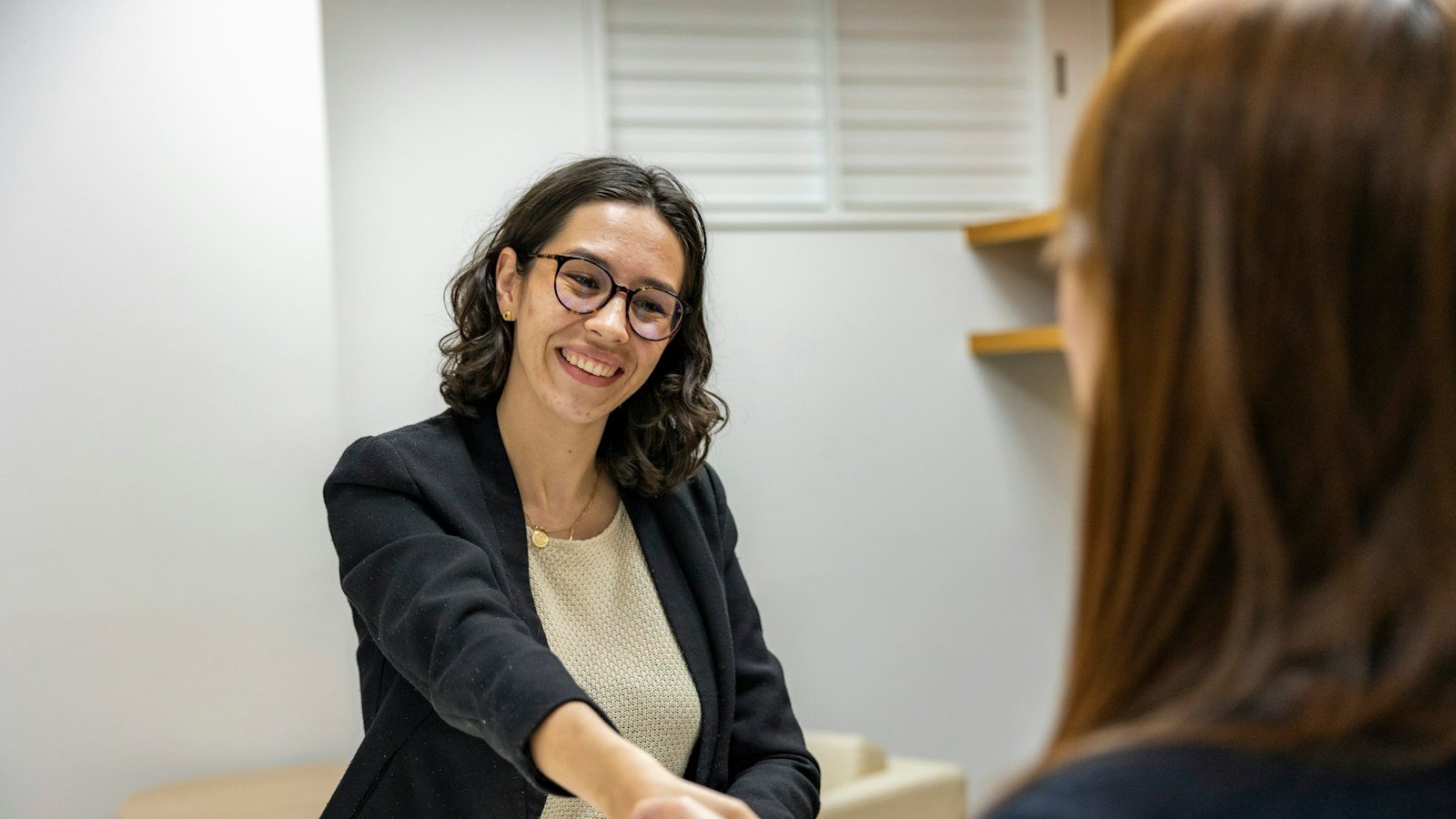 Illustrative job interview handshake, accompanying ManpowerGroup earnings report; not employees of ManpowerGroup