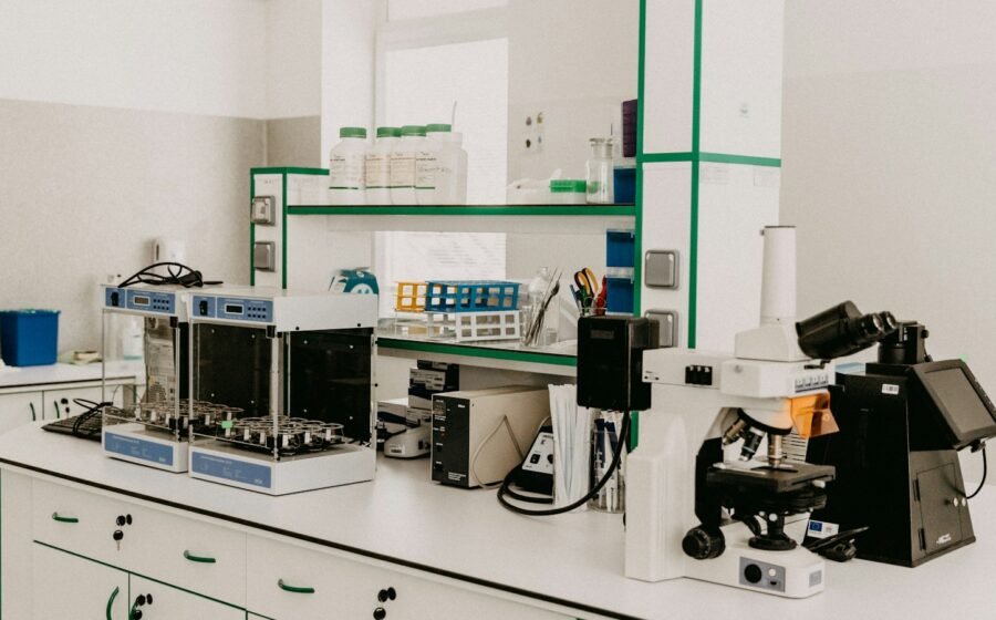 Laboratory microscope illustrating cell research; not a photograph of Candace Pert, Bruce Lipton, or their experiments.
