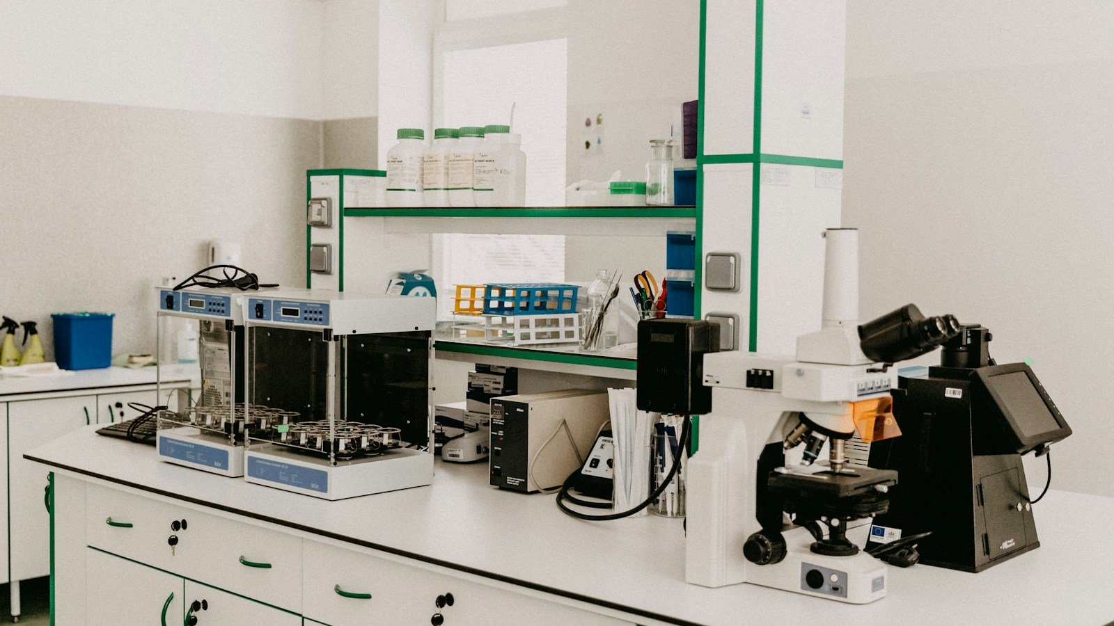 Laboratory microscope illustrating cell research; not a photograph of Candace Pert, Bruce Lipton, or their experiments.