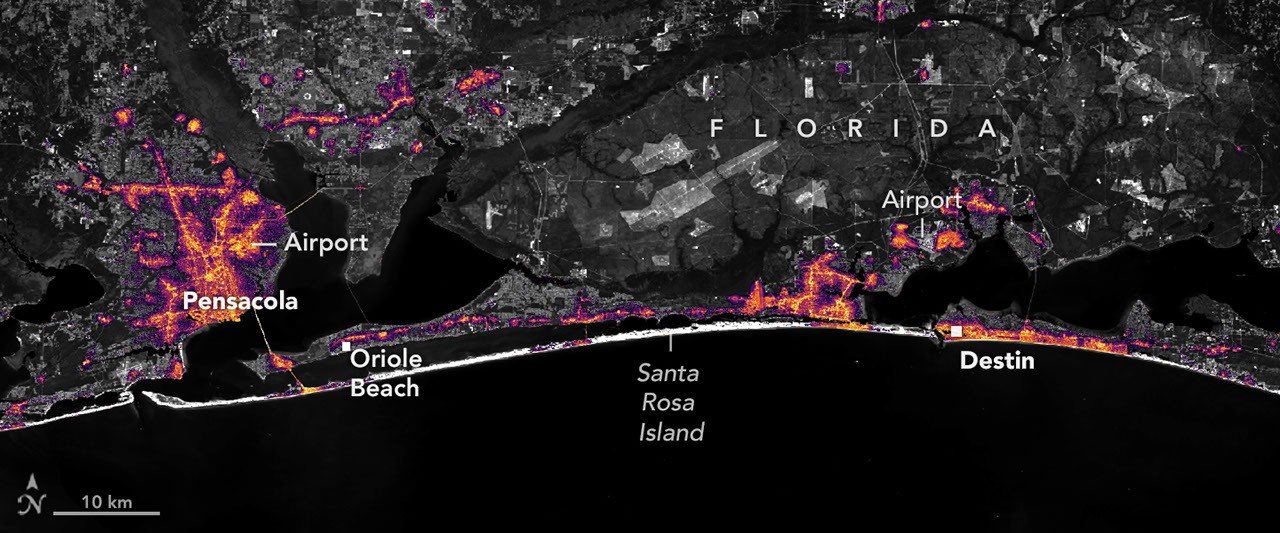An August 2026 composite map showing nighttime lights along the Florida Panhandle between Pensacola and Destin.