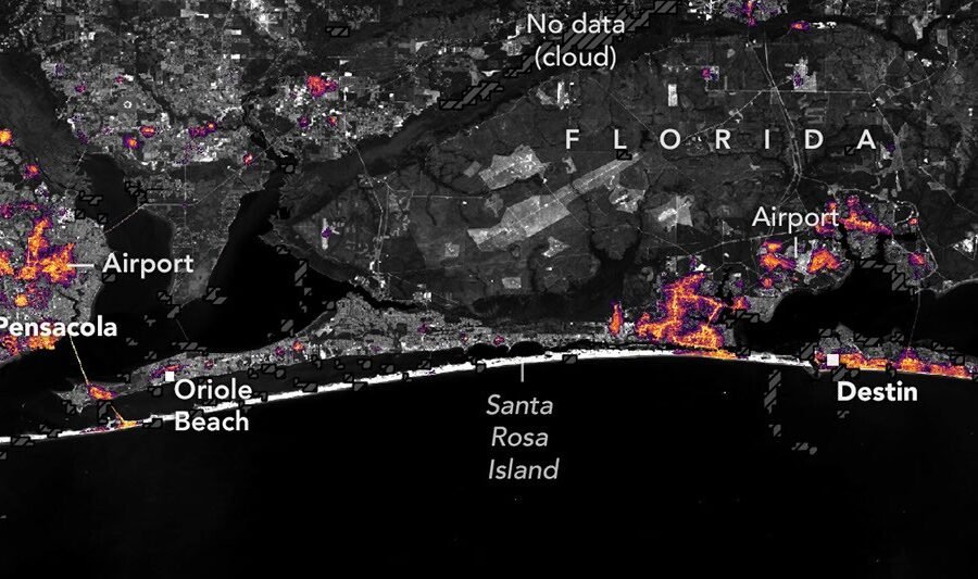Black Marble HD map of nighttime lights near Pensacola and Destin on October 11, 2026, with dimmer areas and a marked cloud-related data gap.