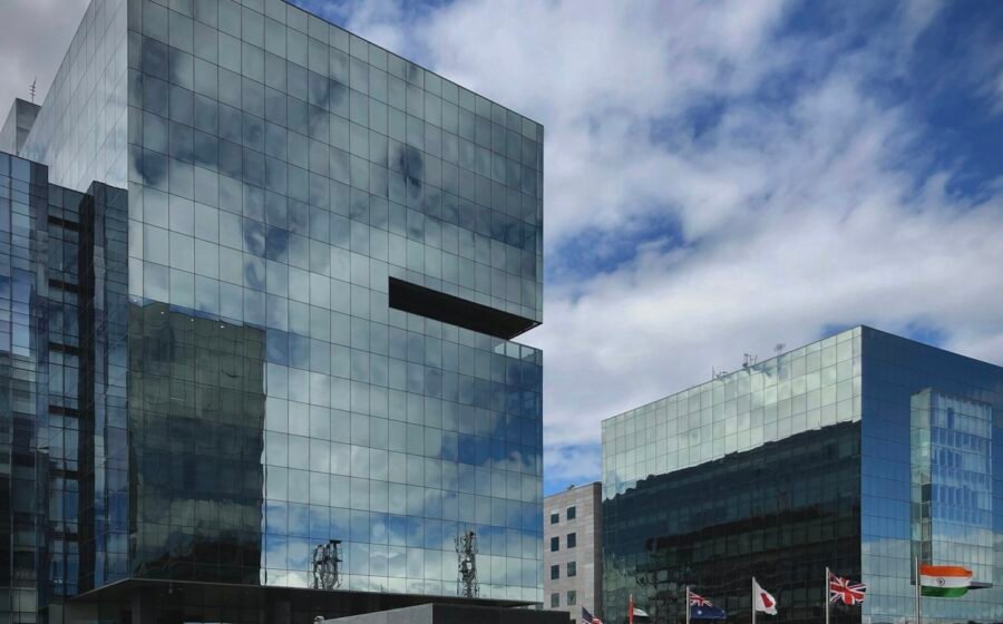 Modern office tower photographed from below; illustrative photograph, not a Wipro property.