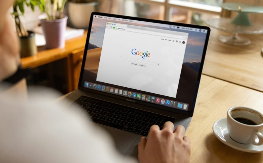Person viewing web search on a laptop, illustrative technology photograph