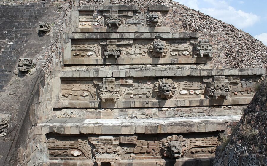 Stone serpent heads and stepped terraces of the Temple of the Feathered Serpent at Teotihuacan, Mexico.