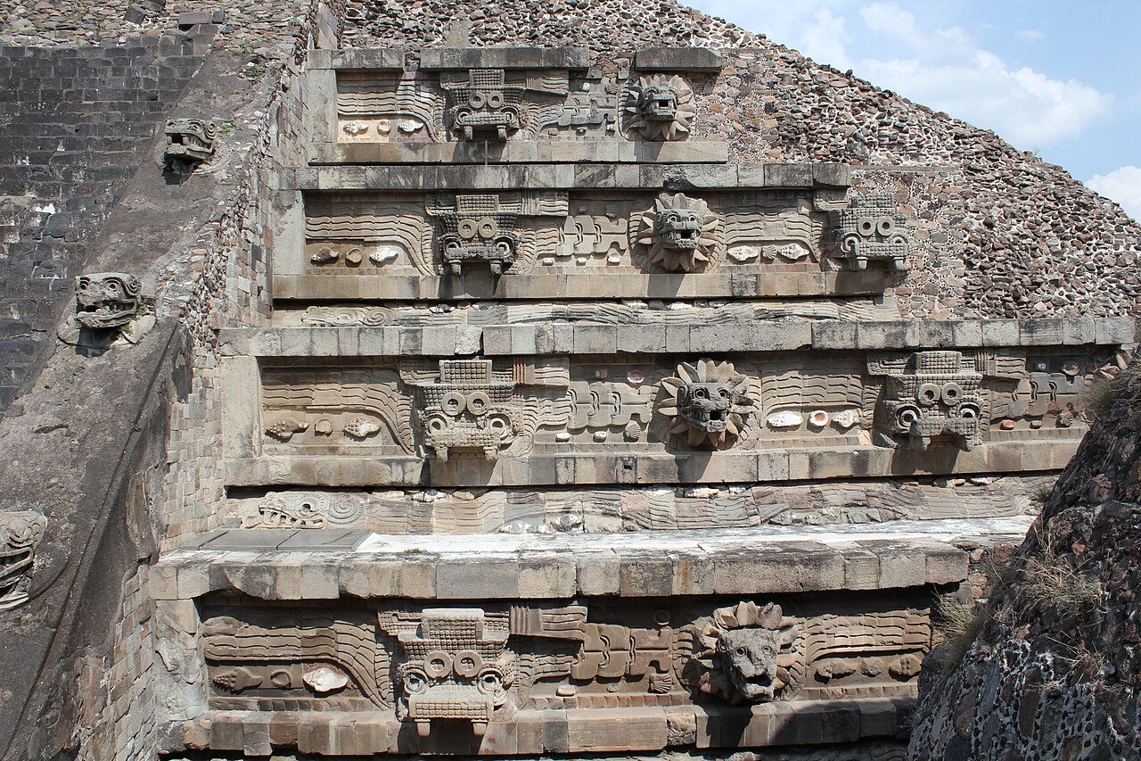 Stone serpent heads and stepped terraces of the Temple of the Feathered Serpent at Teotihuacan, Mexico.